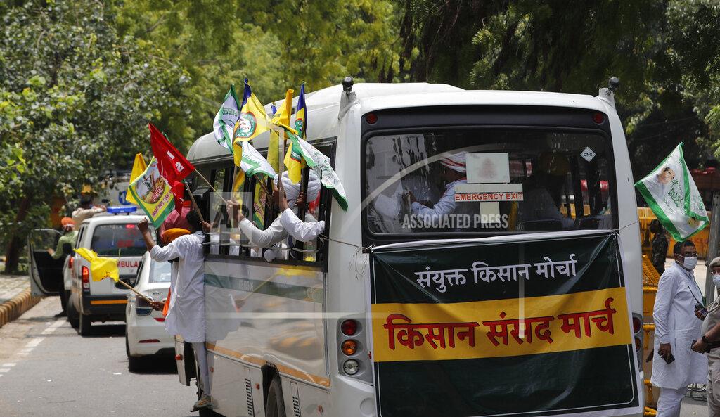 Manish Swarup Indian farmers arrive at a protest site to hold mock farmer's parliament in New Delhi, India, Thursday, July 22, 2021. More than 200 farmers on Thursday began a protest near India's Parliament to mark eight months of their agitation against new agricultural laws that they say will devastate their income. (AP Photo/Manish Swarup)