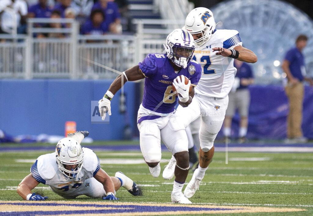 Daniel Lin James Madison running back Kaelon Black (6) shakes off the Morehead State defense as he charges up the field during the first half of an NCAA college football game in Harrisonburg, Va., Saturday, Sept. 4, 2021. (Daniel Lin/Daily News-Record via AP)