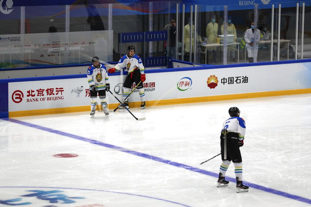 Andy Wong Medical workers wearing face masks watch Capital Institute hockey team players practice at the ice hockey venue set for the 2022 Beijing Winter Olympics at the National Indoor Stadium in Beijing, Thursday, April 1, 2021. Chinese capital holds 10 days test events for 2022 Beijing Winter Olympics in five different venues from April 1-10 and becomes the first city to hold both the Winter and Summer Olympics. (AP Photo/Andy Wong)