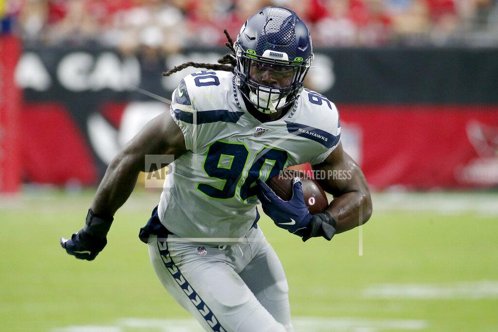 Rick Scuteri Seattle Seahawks outside linebacker Jadeveon Clowney (90) runs in an interception for a touchdown during the first half of an NFL football game against the Arizona Cardinals, Sunday, Sept. 29, 2019, in Glendale, Ariz. (AP Photo/Rick Scuteri)