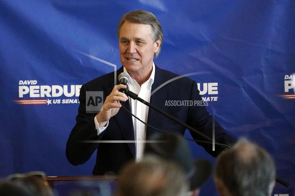 John Bazemore Republican candidate for Senate Sen. David Perdue speaks during a campaign stop at Peachtree Dekalb Airport Monday, Nov. 2, 2020, in Atlanta. The outcome in several contested states will determine whether Joe Biden defeats President Donald Trump. But if the Democratic challenger wins, the ambitions of a Biden presidency could well come down to Georgia. (AP Photo/John Bazemore)
