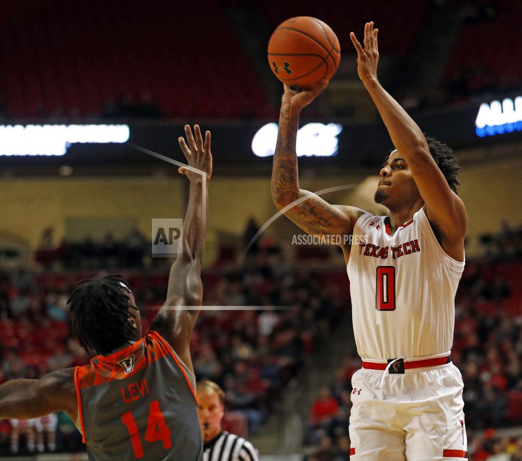 Brad Tollefson Texas Tech's Kyler Edwards (0) shoots over Texas-Rio Grande Valley's Javon Levi (14) during the first half of an NCAA college basketball game Friday, Dec. 28, 2018, in Lubbock, Texas. (AP Photo/Brad Tollefson)