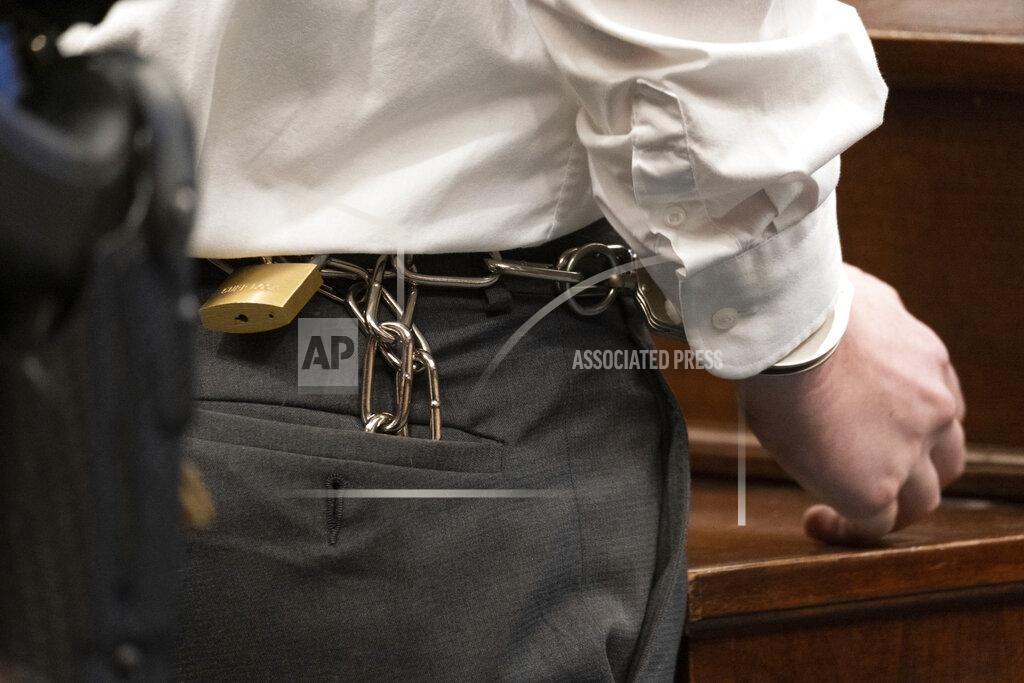 Ben Gray Robert Aaron Long has his hands shackled to his waist as he stands before Judge Ellen McElyea in Superior Court of Cherokee County in Canton, Ga. on Tuesday, July 27, 2021. The man accused of killing eight people, most of them women of Asian descent, at Atlanta-area massage businesses pleaded guilty to four of the murders. He was handed four sentences of life without parole. Robert Aaron Long still faces the death penalty in the four other deaths, which are being prosecuted in a different county. (Ben Gray/Atlanta Journal-Constitution via AP, Pool)