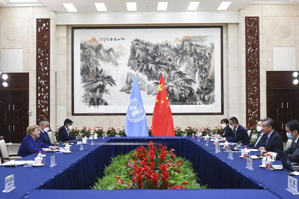Deng Hua In this photo released by Xinhua News Agency, Chinese Foreign Minister Wang Yi, second right, meets with the United Nations High Commissioner for Human Rights Michelle Bachelet, left, in Guangzhou, southern China's Guangdong Province on Monday, May 23, 2022. China opposes “politicizing” human rights and imposing double standards, its foreign minister said in comments at the start of a visit by a top United Nations official focused on allegations of abuses against Muslim minorities in the northwestern region of Xinjiang. (Deng Hua/Xinhua via AP)