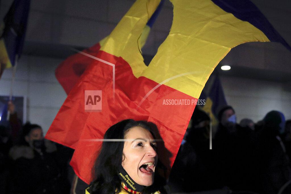Vadim Ghirda A woman shouts slogans during a protest outside the health ministry after a deadly fire at a hospital treating COVID-19 patients in Bucharest, Romania, Saturday, Jan. 30, 2021. Hundreds marched during a protest organized by the AUR alliance demanding the resignation of several top officials, after a fire early Friday at a key hospital in Bucharest that also treats COVID-19 patients killed five people. (AP Photo/Vadim Ghirda)