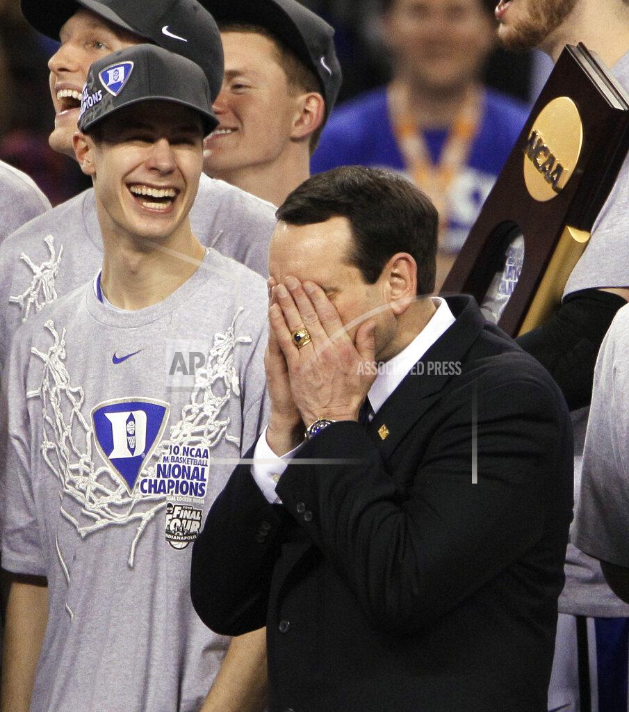 Amy Sancetta FILE - In this April 5, 2010, file photo, Duke head coach Mike Krzyzewski is overcome with emotion after Duke's 61-59 win over Butler in the men's NCAA Final Four college basketball championship game in Indianapolis. At left is Duke guard Jon Scheyer. (AP Photo/Amy Sancetta, Fle)