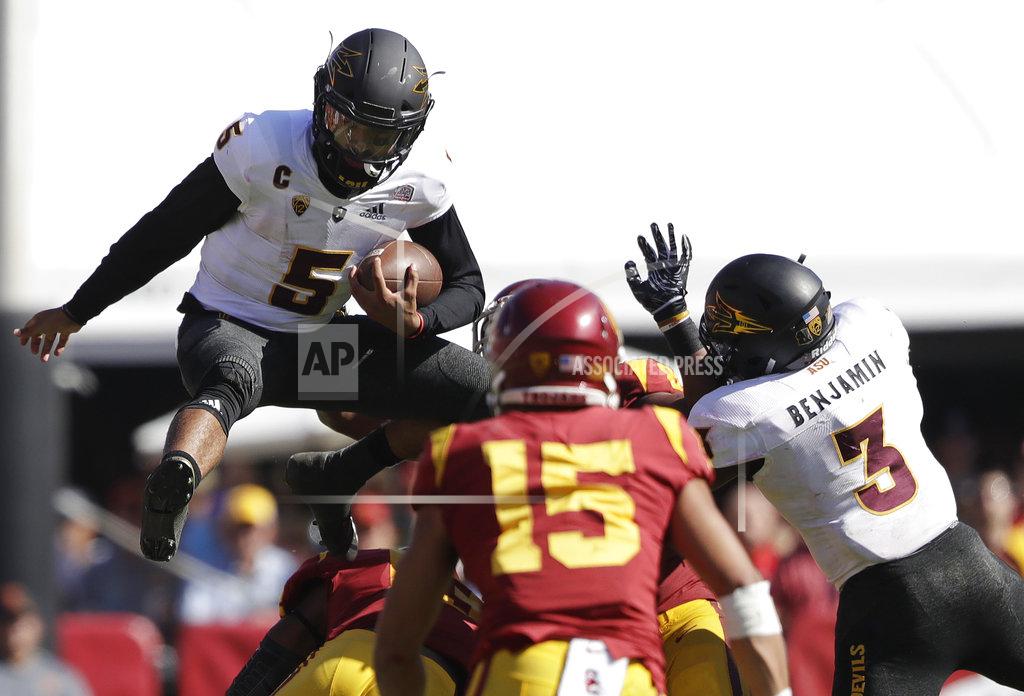 Marcio Jose Sanchez Arizona State quarterback Manny Wilkins, top left, leaps over Southern California linebacker Levi Jones, bottom left, during the first half of an NCAA college football game Saturday, Oct. 27, 2018, in Los Angeles. (AP Photo/Marcio Jose Sanchez)