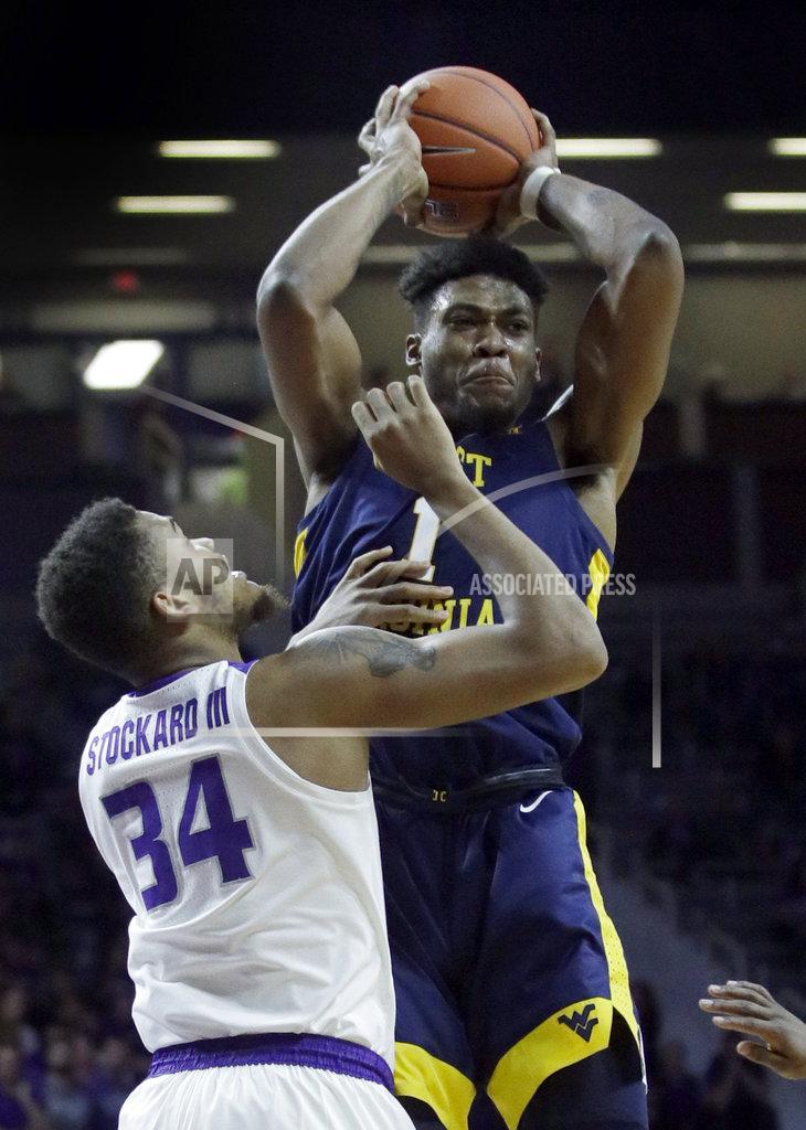 Orlin Wagner West Virginia forward Derek Culver (1) passes to a teammate while covered by Kansas State forward Levi Stockard III (34) during the first half of an NCAA college basketball game in Manhattan, Kan., Wednesday, Jan. 9, 2019. (AP Photo/Orlin Wagner)