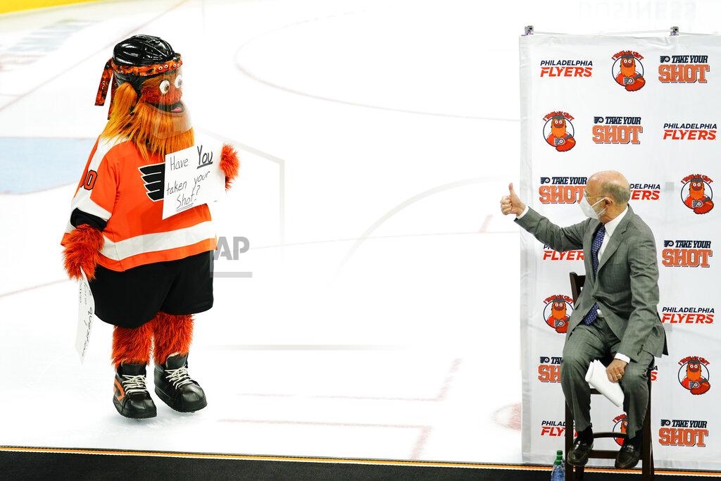 Matt Rourke Gov. Tom Wolf gives the thumbs up to Philadelphia Flyers' mascot, Gritty, during a news conference encouraging people to get the COVID-19 vaccine, in Philadelphia, Monday, May 3, 2021. (AP Photo/Matt Rourke)