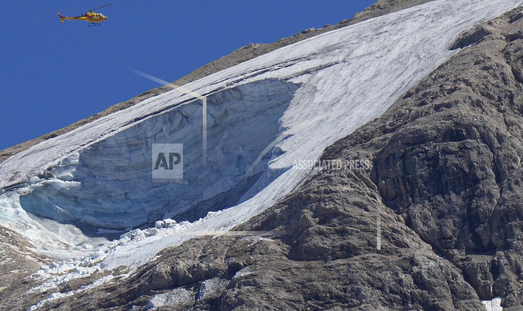 Luca Bruno FILE - A rescue helicopter hovers over the Punta Rocca glacier near Canazei, in the Italian Alps in northern Italy, July 4, 2022, a day after a huge chunk of the glacier broke loose, sending an avalanche of ice, snow, and rocks onto hikers. Italy was enduring a prolonged heat wave before a massive piece of the Alpine glacier broke off and killed hikers on Sunday and experts say climate change will make those hot, destabilizing conditions more common. (AP Photo/Luca Bruno, File)