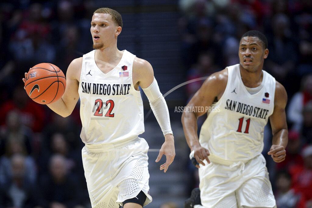 Orlando Ramirez San Diego State guard Malachi Flynn (22) dribbles the ball ahead of forward Matt Mitchell (11) during the first half of the team's NCAA college basketball game against Cal Poly on Saturday, Dec. 28, 2019, in San Diego. (AP Photo/Orlando Ramirez)