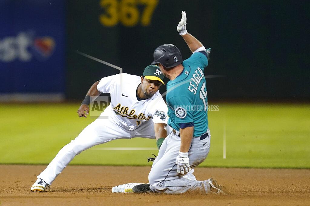 Jeff Chiu Seattle Mariners' Kyle Seager, right, is tagged out by Oakland Athletics shortstop Elvis Andrus trying to advance to second base on an RBI-single during the fifth inning of a baseball game in Oakland, Calif., Monday, Sept. 20, 2021. (AP Photo/Jeff Chiu)