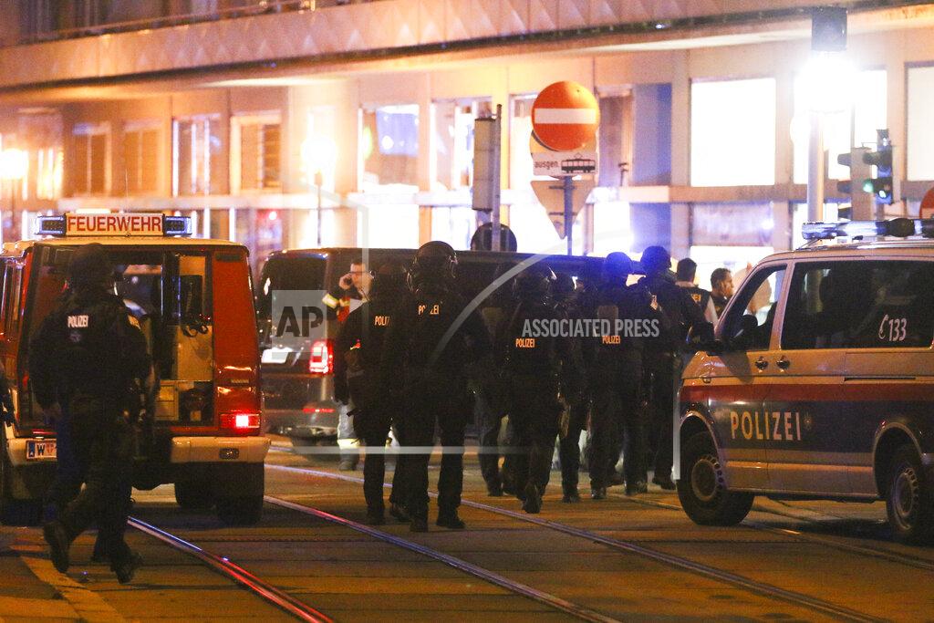 Ronald Zak Police officers walk between emergency vehicles at the scene after gunshots were heard, in Vienna, Monday, Nov. 2, 2020. Austrian police say several people have been injured and officers are out in force following gunfire in the capital Vienna. Initial reports that a synagogue was the target of an attack couldn't immediately be confirmed. Austrian news agency APA quoted the country's Interior Ministry saying one attacker has been killed and another could be on the run.(Photo/Ronald Zak)