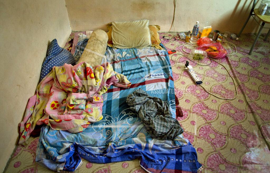 Gemunu Amarasinghe Pillows and blankets are seen in the sleeping area of Bangladeshi palm oil worker, Karim, at a house he shares with others in peninsular Malaysia, Wednesday, March 6, 2019. "I have been cheated five times in six years," said Karim, a migrant worker who arrived in Malaysia legally after being promised a position in an electronics company, only to end up working for a subcontractor on several plantations owned by the biggest companies. He says once when he asked for his unpaid wages, his boss "threatened to run me over with his car." (AP Photo/Gemunu Amarasinghe)