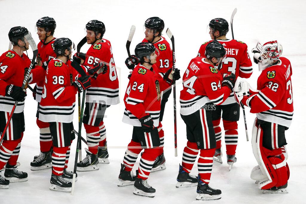 Jeff Haynes Chicago Blackhawks goaltender Kevin Lankinen (32) celebrates with teammates after defeating the Columbus Blue Jackets in an NHL hockey game Sunday, Jan. 31, 2021, in Chicago. (AP Photo/Jeff Haynes)