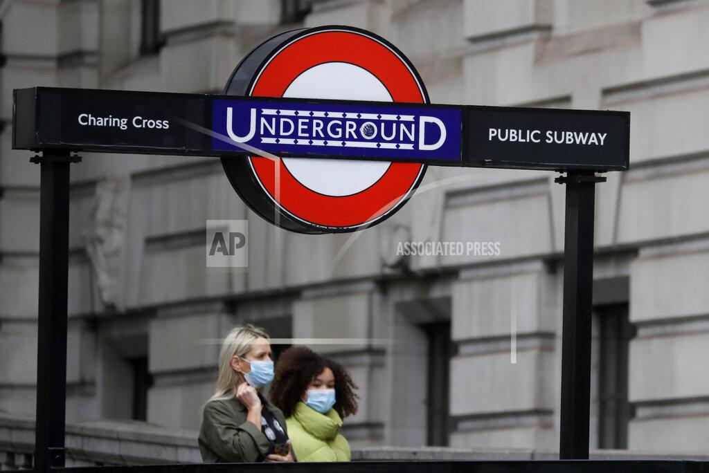 Pedestrians wear masks as they walk near Charing Cross Station in London, Friday, June 5, 2020. It will become compulsory to wear face coverings whilst using public transport in England from Monday June 15. (AP Photo/Kirsty Wigglesworth)