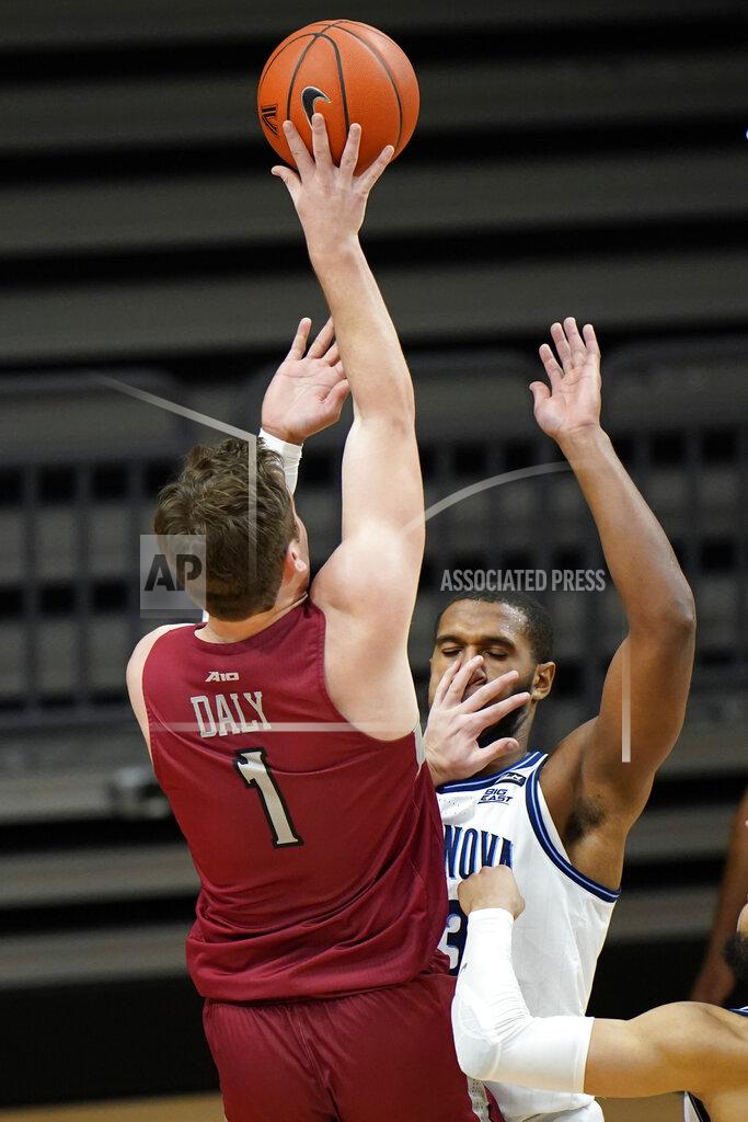 Matt Slocum Saint Joseph's Ryan Daly, left, goes up for a shot against Villanova's Eric Dixon during the second half of an NCAA college basketball game, Saturday, Dec. 19, 2020, in Villanova, Pa. (AP Photo/Matt Slocum)