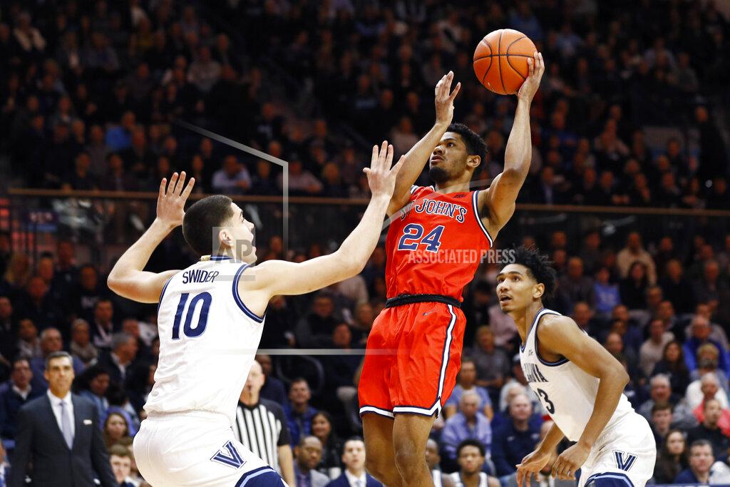 Matt Slocum St. John's Nick Rutherford (24) goes up for a shot between Villanova's Cole Swider (10) and Jermaine Samuels (23) during the first half of an NCAA college basketball game, Wednesday, Feb. 26, 2020, in Villanova, Pa. (AP Photo/Matt Slocum)