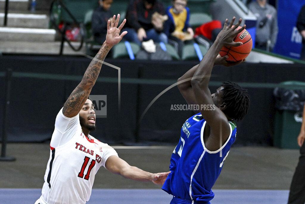 Matt Strasen Texas A&M-CC forward Perry Francois (10) shoots over Texas Tech guard Kyler Edwards (11) in the first half of an NCAA college basketball game in Frisco, Texas, Saturday, Dec. 12, 2020. (AP Photo/Matt Strasen)