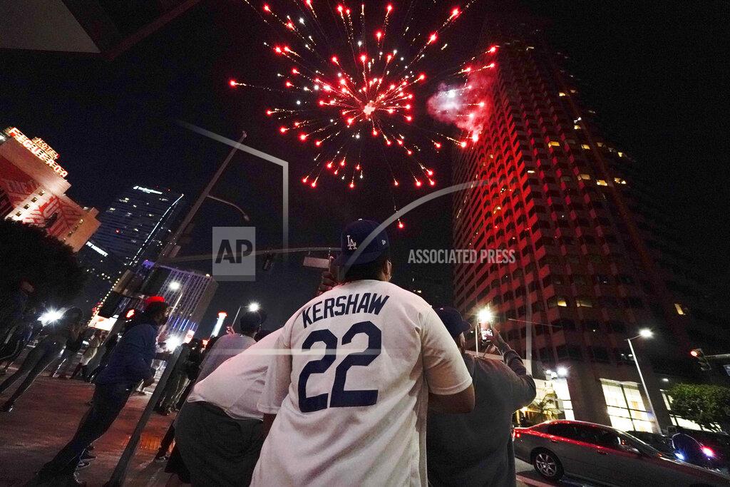 Ashley Landis Baseball fans celebrate downtown after the Los Angeles Dodgers won the World Series over the Tampa Bay Rays Tuesday, Oct. 27, 2020, in Los Angeles. (AP Photo/Ashley Landis)