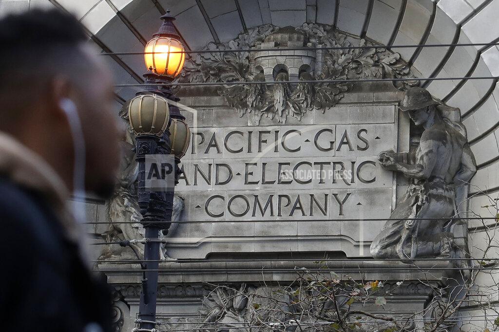 Jeff Chiu FILE - In this Dec. 16, 2019, file photo, a sign to a Pacific Gas & Electric building is shown in San Francisco. California power regulators are poised to reprimand PG&E for continuing to neglect its electrical grid that has ignited a series of deadly wildfires in Northern California and could order the utility to do be more vigilant in the upcoming months of hot, windy weather. The anticipated rebuke from the California Public Utilities Commission Thursday, April 15, 2021, would serve as official notice to PG&E that it hasn't been doing enough to reduce the risks posed by a combination of crumbling equipment and overgrown trees susceptible to touching or toppling into nearby power lines. (AP Photo/Jeff Chiu, File)