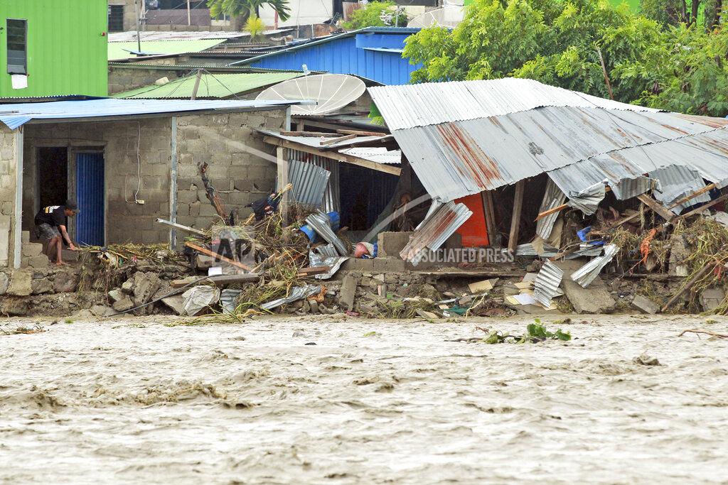 Kandhi Barnez A man inspects buildings damaged by a flood in Dili, East Timor, Monday, April 5, 2021. Multiple disasters caused by torrential rains in eastern Indonesia and neighboring East Timor have left dozens of people dead and missing and displaced thousands. (AP Photo/Kandhi Barnez)