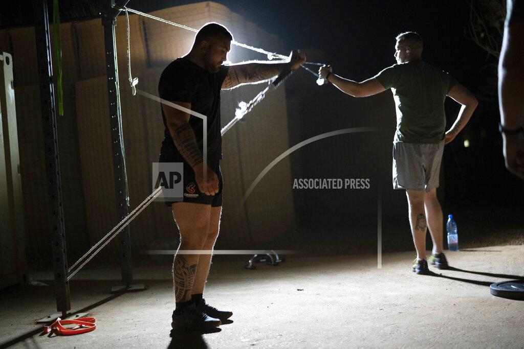 Uncredited French Barkhane force soldiers work out at their base in Gao, Mali Tuesday June 8, 2021. After France suspended joint military operations with Malian forces after the junta led by Col. Assimi Goita retook control of Mali's transitional government May 24 2021, French President Emmanuel Macron announced at a press conference Thursday June 10, 2021 That operation Barkhane would end and be replaced by support for local partners and counter terrorism. (AP Photo/Jerome Delay)