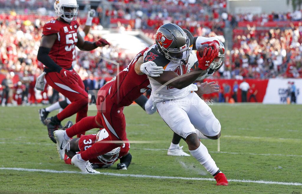 Mark Lomoglio Tampa Bay Buccaneers running back Peyton Barber (25) slips a tackle by Arizona Cardinals linebacker Joe Walker (59) to score on a 1-yard touchdown run during the second half of an NFL football game Sunday, Nov. 10, 2019, in Tampa, Fla. (AP Photo/Mark LoMoglio)