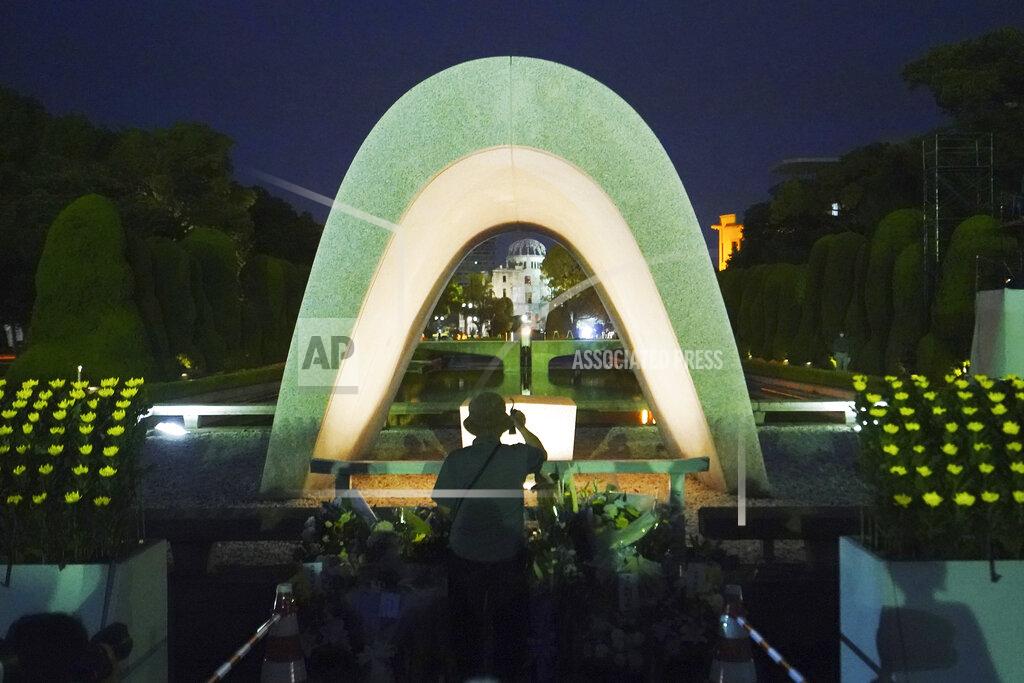 Eugene Hoshiko A visitor prays in front of the cenotaph for the atomic bombing victims before the start of a ceremony to mark the 75th anniversary of the U.S. bombing in Hiroshima, western Japan, early Thursday, Aug. 6, 2020. (AP Photo/Eugene Hoshiko)