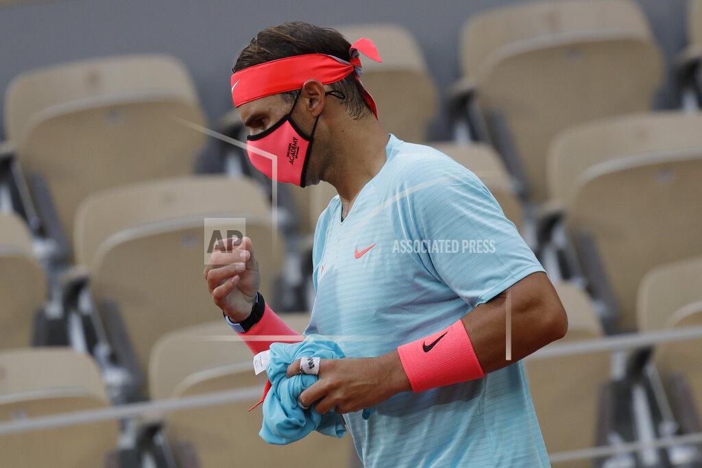 Alessandra Tarantino Spain's Rafael Nadal wears a face mask during a break in the first round match of the French Open tennis tournament against Egor Gerasimov of Belarus at the Roland Garros stadium in Paris, France, Monday, Sept. 28, 2020. (AP Photo/Alessandra Tarantino)