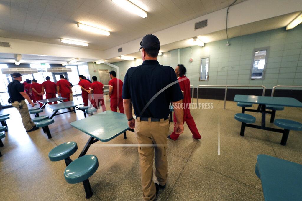 Gerald Herbert FILE — Immigration detainees leave the cafeteria under the watch of guards during a media tour at the Winn Correctional Center in Winnfield, La., in this Thursday, Sept. 26, 2019 file photo. The number of detainees nationwide has more than doubled since the end of February 2021, to nearly 27,000, according to recent data from U.S. Immigration and Customs Enforcement. (AP Photo/Gerald Herbert, File)