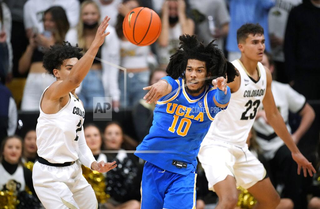 David Zalubowski UCLA guard Tyger Campbell (10) passes the ball as Colorado guard KJ Simpson defends during the second half of an NCAA college basketball game Saturday, Jan. 22, 2022, in Boulder, Colo. UCLA won 71-65. (AP Photo/David Zalubowski)