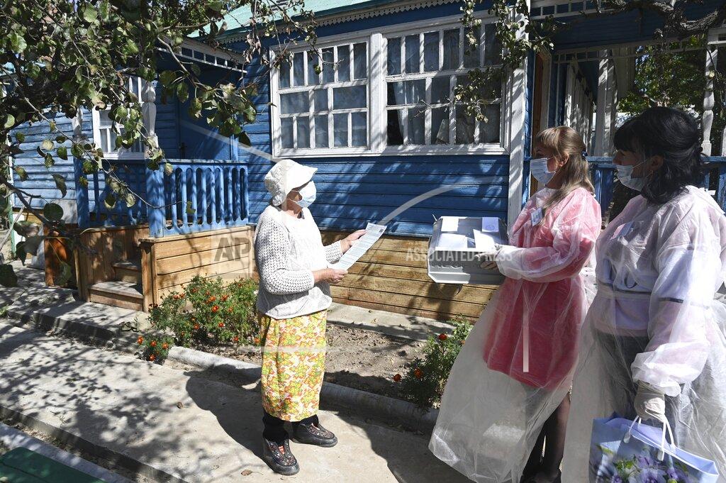 Uncredited An elderly woman prepares to cast her ballot near her house in Starozolotovsky village, 160 km (100 miles) north of Rostov-on-Don during the Parliamentary elections , Russia, Saturday, Sept. 18, 2021. Sunday is the last of three days voting for a new parliament, but there seems to be no expectation that United Russia, the party devoted to President Vladimir Putin, will lose its dominance in the State Duma. (AP Photo)
