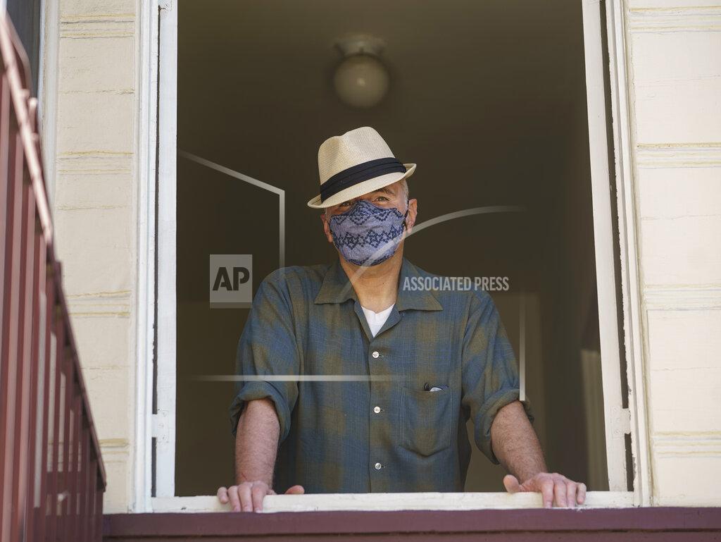 Damian Dovarganes Nathan Long, a video game writer, poses for a picture inside his rental apartment in Glendale, Calif., Thursday, April 8, 2021. He and his wife, Lili, have been unsuccessful so far in their search for a home in Los Angeles. (AP Photo/Damian Dovarganes)