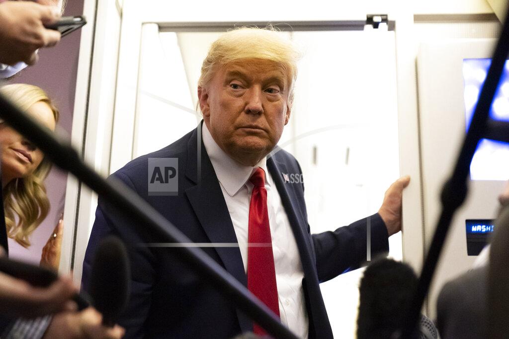 Alex Brandon President Donald Trump leans in to hear a question as he speaks with reporters while in flight on Air Force One after a campaign rally at Tucson International Airport, in Tucson, Ariz., Monday, Oct. 19, 2020, while en route to Andrews Air Force Base, Md. (AP Photo/Alex Brandon)