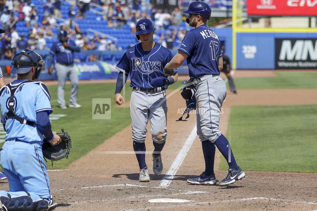 Mike Carlson Tampa Bay Rays' Austin Meadows, right, celebrates as his walk scores Taylor Walls in front of Toronto Blue Jays catcher Danny Jansen during the ninth inning of a baseball game Sunday, May 23, 2021, in Dunedin, Fla. (AP Photo/Mike Carlson)