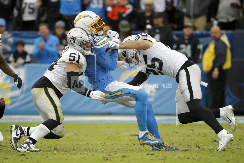 Marcio Jose Sanchez Los Angeles Chargers wide receiver Mike Williams, middle, is tackled by Oakland Raiders inside linebacker Will Compton, left, and free safety Erik Harris during the second half of an NFL football game Sunday, Dec. 22, 2019, in Carson, Calif. (AP Photo/Marcio Jose Sanchez)