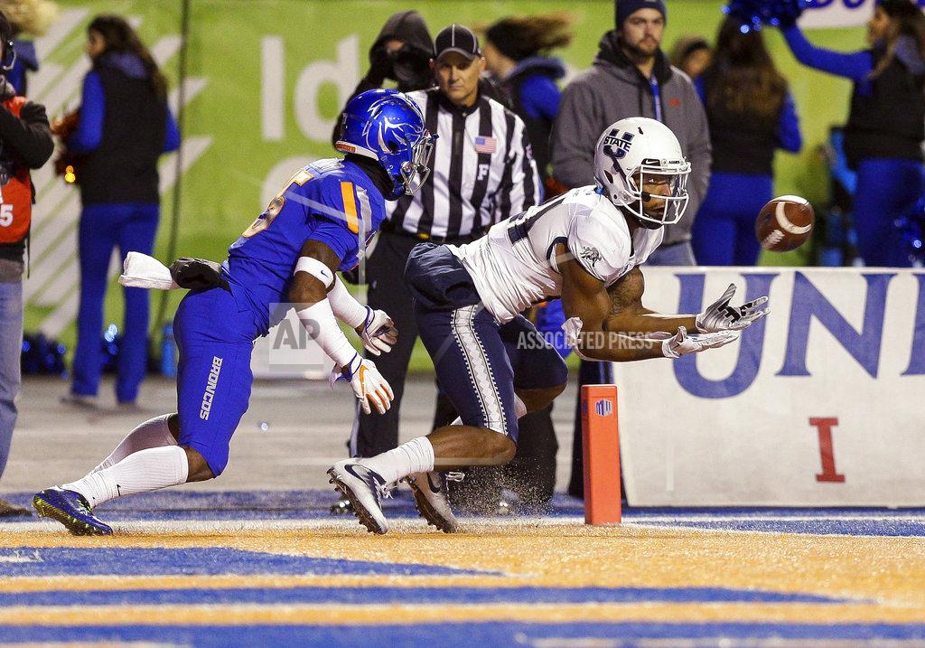 Steve Conner Utah State wide receiver Jalen Greene (21) catches a pass for a touchdown in front of Boise State cornerback Jalen Walker, left, during the first half of an NCAA college football game Saturday, Nov. 24, 2018, in Boise, Idaho. (AP Photo/Steve Conner)