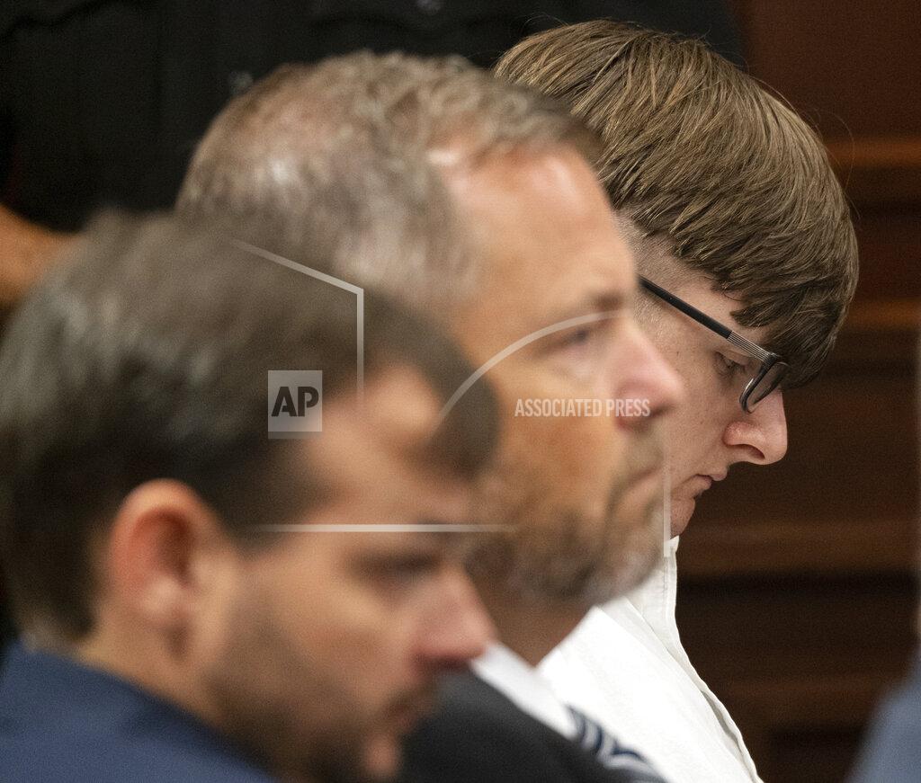 Ben Gray Robert Aaron Long sits among his lawyers in Superior Court of Cherokee County in Canton, Ga. on Tuesday, July 27, 2021. The man accused of killing eight people, most of them women of Asian descent, at Atlanta-area massage businesses pleaded guilty to four of the murders. He was handed four sentences of life without parole. Robert Aaron Long still faces the death penalty in the four other deaths, which are being prosecuted in a different county. (Ben Gray/Atlanta Journal-Constitution via AP, Pool)