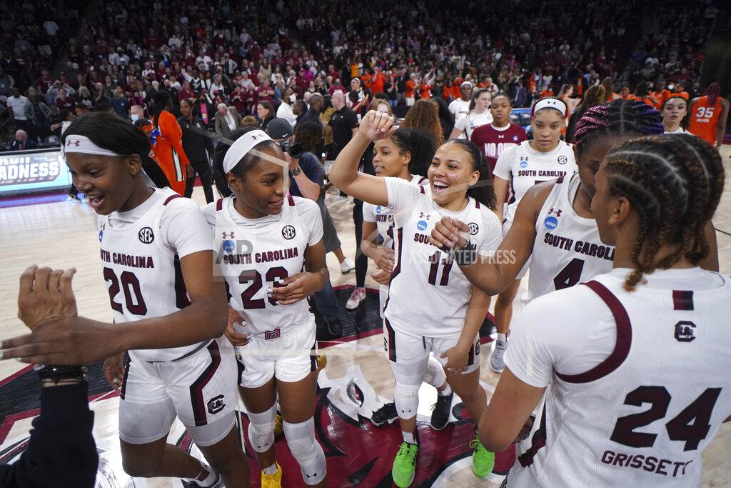 Sean Rayford South Carolina guard Destiny Littleton (11), guard Bree Hall (23), and forward Sania Feagin (20) celebrate with their teammates after a second-round game against Miami in the NCAA college basketball tournament Sunday, March 20, 2022 in Columbia, S.C. South Carolina won 49-33. (AP Photo/Sean Rayford)