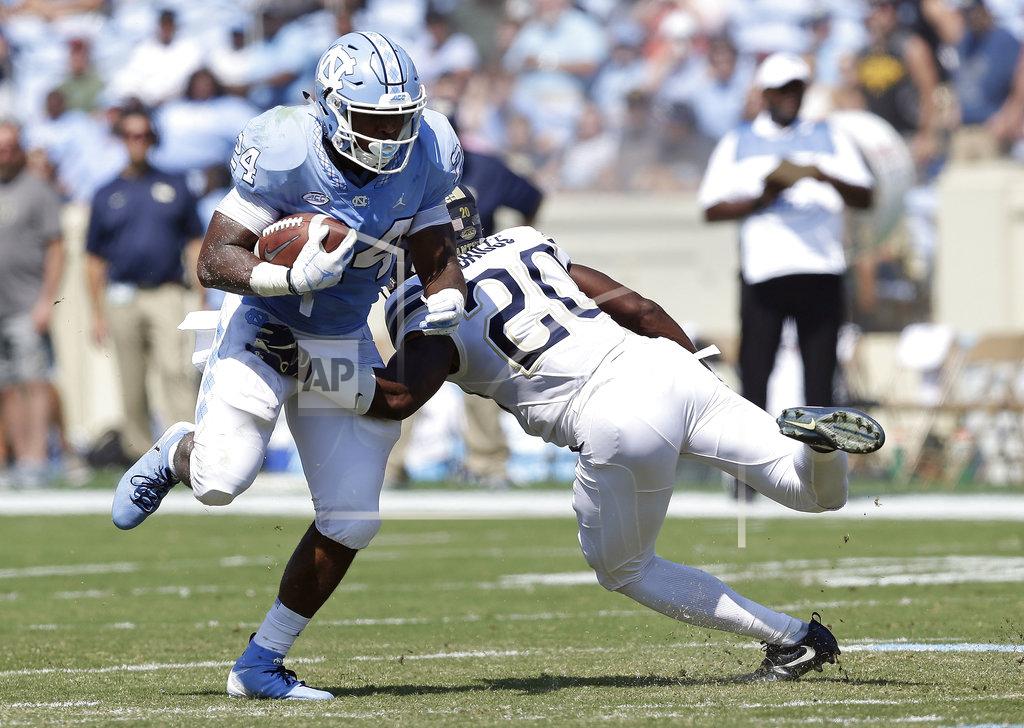 Gerry Broome North Carolina's Antonio Williams (24) runs the ball while Pittsburgh's Dennis Briggs (20) tries to make the tackle during the first half of an NCAA college football game in Chapel Hill, N.C., Saturday, Sept. 22, 2018. (AP Photo/Gerry Broome)