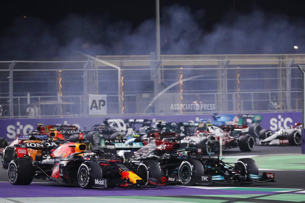 Amr Nabil Red Bull driver Max Verstappen of the Netherlands, left, and Mercedes driver Lewis Hamilton of Britain in action during the Formula One corniche circuit, in Jiddah, Saudi Arabia, Sunday, Dec. 5, 2021. (AP Photo/Amr Nabil)