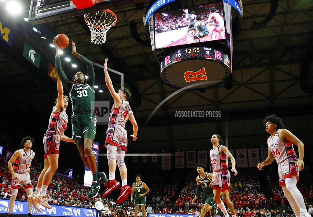 Noah K. Murray Michigan State forward Marcus Bingham Jr. (30) drives to the basket against Rutgers forward Dean Reiber (21) and guard Paul Mulcahy (4) during the first half of an NCAA college basketball game in Piscataway, N.J., Saturday, Feb. 5, 2022. (AP Photo/Noah K. Murray)