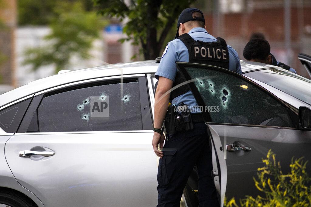 Ashlee Rezin Garcia Chicago police investigate in the 700 block of North Spaulding Avenue, where a 40-year-old man was shot multiple times while he was riding in a car on the West Side on Memorial Day, Monday night, May 31, 2021, in Chicago. (Ashlee Rezin Garcia/Chicago Sun-Times via AP)