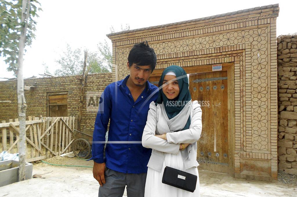 Uncredited In this photo released by Nursimangul Abdureshid, Memetali Abdureshid poses for a picture with his sister Nursimangul Abdureshid outside their family home in Sayibage township in China's far west Xinjiang region in August 2013. Nearly one in 25 people in a county in the Uyghur heartland of China has been sentenced to prison on terrorism-related charges, in what is the highest known imprisonment rate in the world, an Associated Press review of leaked data shows. Memetali Abdureshid, who ran a car repair shop, was listed as being sentenced to 15 years and 11 months in prison on charges of "picking quarrels and provoking trouble” and “preparing to carry out terrorist activities." (Nursimangul Abdureshid via AP)