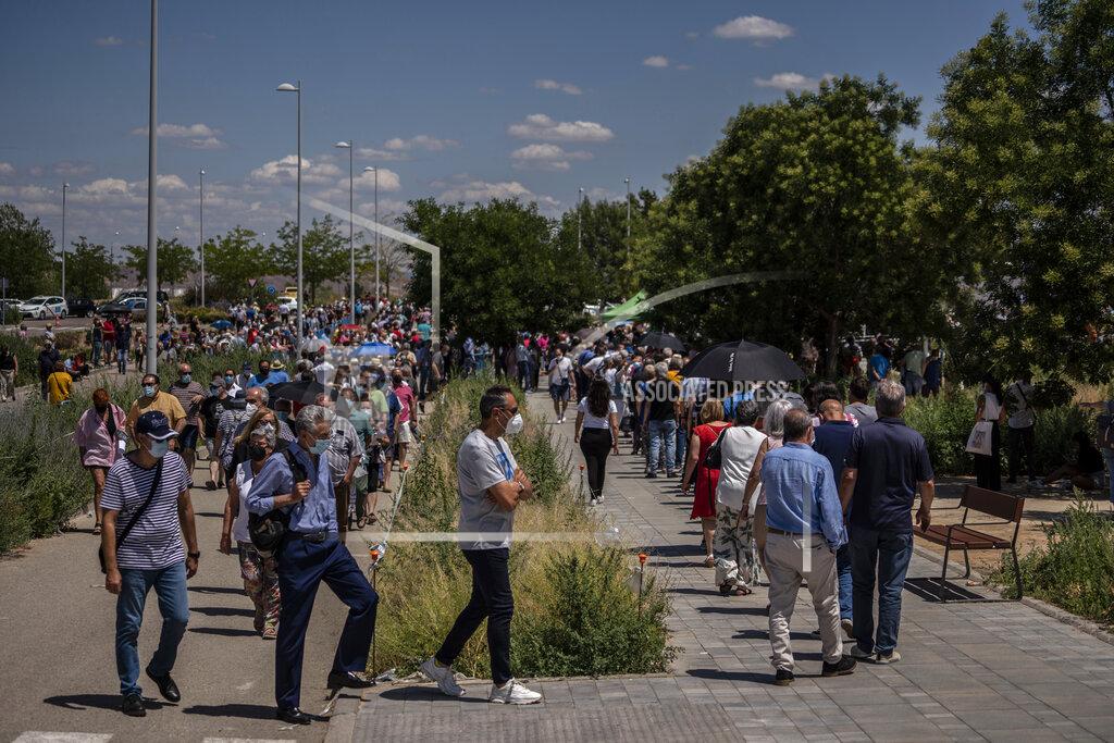 Olmo Calvo Hundreds of people queue to be vaccinated against COVID-19 at the Enfermera Isabel Zendal Hospital in Madrid, Spain, Tuesday, July 7, 2021. Spain is trying to stamp out a new wave of COVID-19 among its youth thanks to a robust vaccination program that is widely supported. Spain like the rest of the European Union got off to a slow start to compared to the United States and Britain when the first vaccines were released. But it has quickly made up ground once deliveries by drug makers started flowing. (AP Photo/Olmo Calvo)