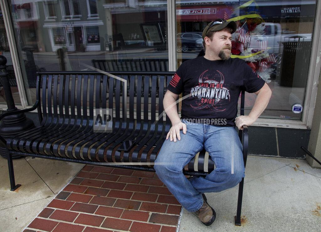 Brynn Anderson U.S. Marine Corps veteran Chad Sneary, 43, sits on a bench. Sneary was laid off from his manufacturing job in April. Sneary waits for unemployment to come through. "Financial skills is not something the military ever taught you," he said on Thursday, April 30, 2020, in Mooresville, N.C. (AP Photo/Sarah Blake Morgan)