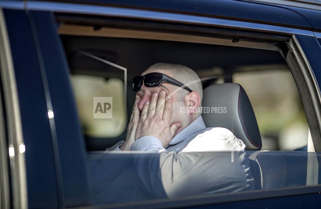 David Goldman Jason Boxer wipes away tears while observing from the car the burial of his father, Allen Boxer, at Mount Richmond Cemetery in the Staten Island borough of New York, Sunday, April 12, 2020. "He was kind and gentle and had the biggest heart of anyone you'd know," said Boxer of his father, a U.S. Army veteran. "It's hard, very hard," he added of not being able to stand at the grave during the service. (AP Photo/David Goldman)