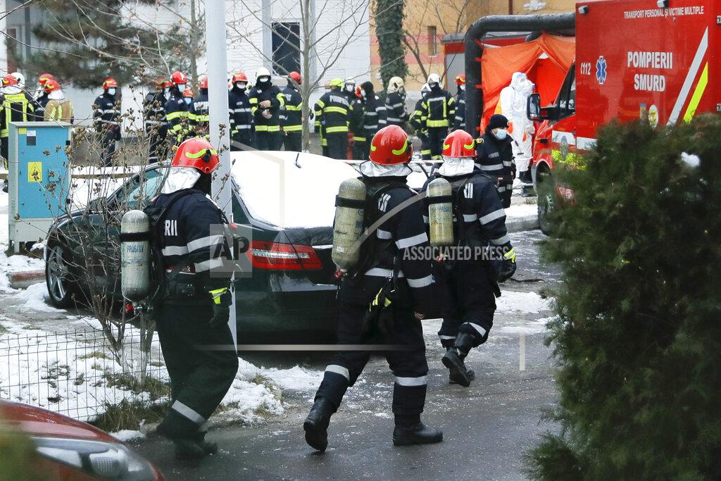 Vadim Ghirda Firefighters walk at the the Matei Bals hospital compound after a fire broke out in one of its buildings in Bucharest, Romania, Friday, Jan. 29, 2021. A fire early Friday at a key hospital in Bucharest that also treats COVID-19 patients killed four people, authorities said. (AP Photo/Vadim Ghirda)