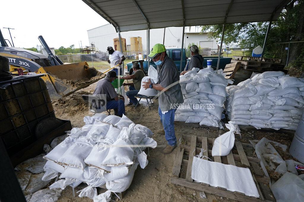 Gerald Herbert Municipal workers fill sandbags for the elderly and those with disabilities ahead of Hurricane Laura in Crowley, La., Tuesday, Aug. 25, 2020. (AP Photo/Gerald Herbert)
